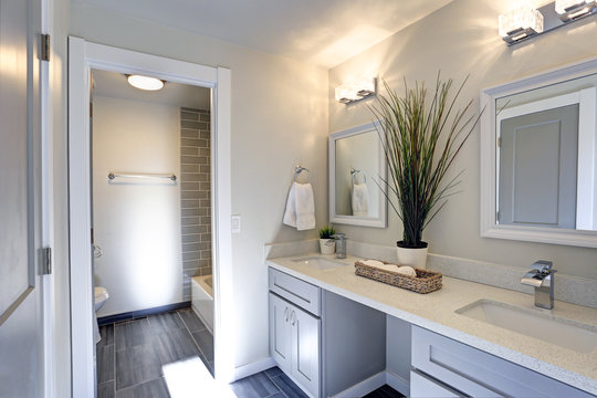 Warm and clean bathroom with grey double vanity cabinet