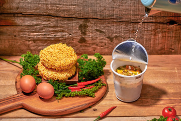 instant noodle, asian fast food, noodle cup on wooden background.