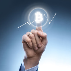 the man clicks Icon Bitcoin on virtual screen.