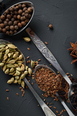 Various spices spoons on stone table.On dark concrete background.              Herbs and spices on wooden table. 