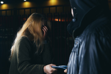 Dangerous man and young woman on the street