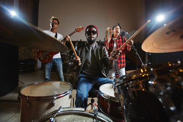 Popular music band performing songs and playing musical instruments