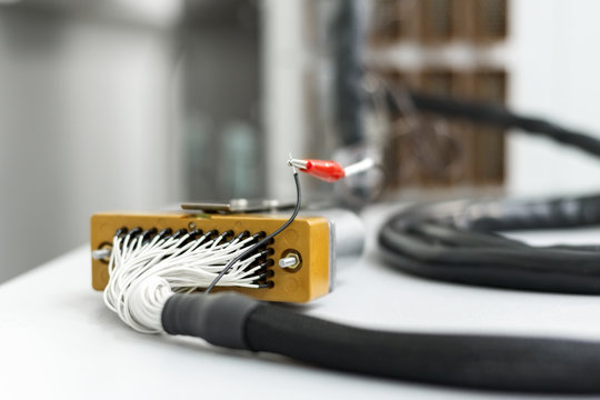 Fragment of electrical cable with rectangular multi-pin connector.
