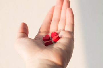 little red hearts lying in a hand