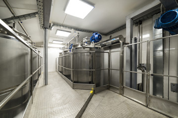 A long gangway between two rows of cisterns. Storage of food liquids.