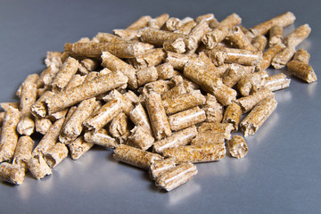 Biofuels. Wood pellets on a silver background.Pellets Biomass - cheap energy.