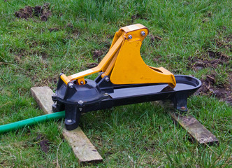 Yellow livestock nose pump in a meadow