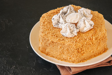 Honey cake with meringue decoration on top.