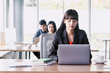 Businesswoman working on notebook computer and business document at office