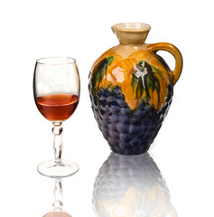 glass of wine and ceramic decanter