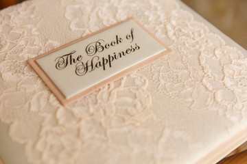 Wedding book for writing best wishes on wedding day. Album for marriage memories for bride and groom. Scrapbook with inscription ''The Book of Happiness''