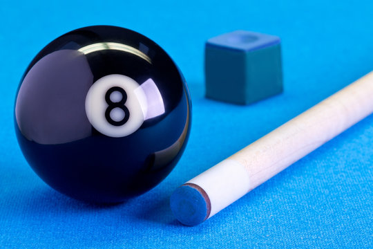 Billiard pool game eight ball with chalk and cue on billiard table