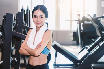 Fototapeta premium Sporty woman with towel in the gym