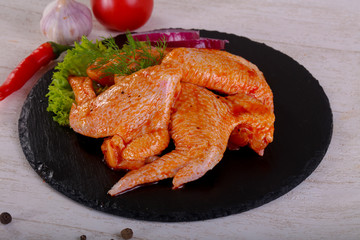 Raw marinated chicken wings