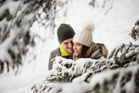 Young couple in love - snowy background.