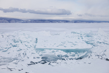 Fototapeta na wymiar Turquoise ice floe. Ice-drift of Baikal lake. Winter landscape.