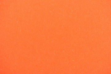 texture of bright orange paper as background