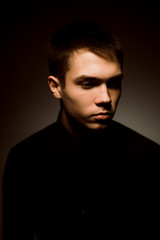 Fototapeta premium young guy on a dark studio background