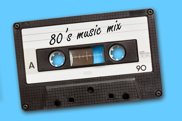 80's music mix written on vintage audio cassette tape, blue background