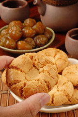 Female hand holding crisp walnut cookie    