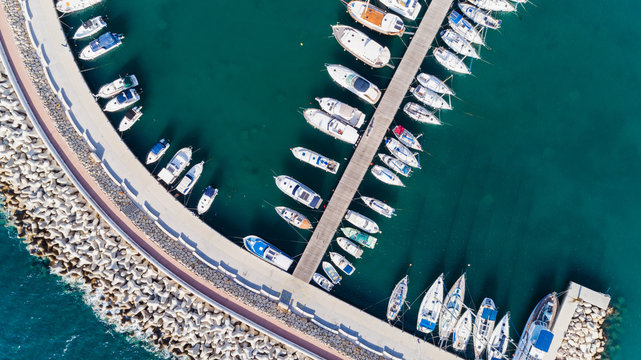 Aerial Bird's Eye View Of Zygi Fishing Village Port, Larnaca, Cyprus. Bird Eye View Of Aligned Fish Boats Moored In The Harbour, Docked Yachts, Pier, Wave Breaker Rocks Near Limassol City From Above. 