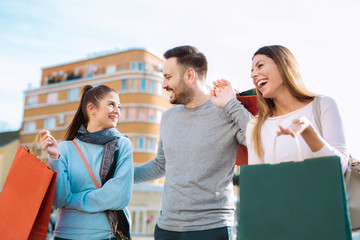 Happy friends shopping. Young friends enjoying shopping in the city.