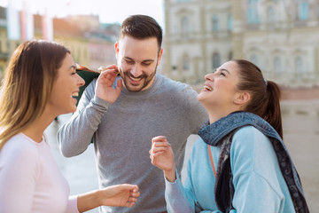 Happy friends shopping. Young friends enjoying shopping in the city.
