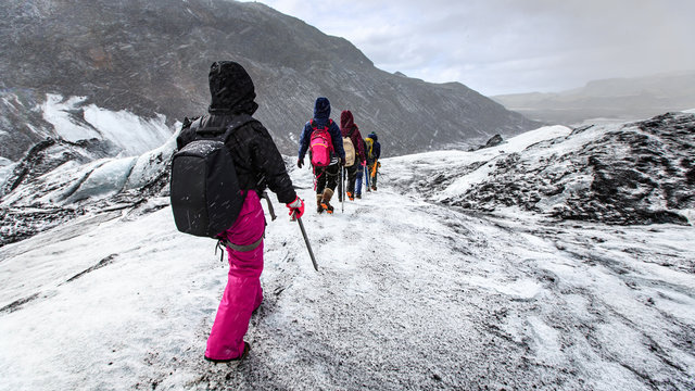 Group of hiker walk on glacier during snow on Solheimajokull,