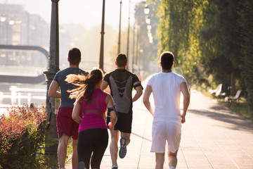 group of young people jogging in the city