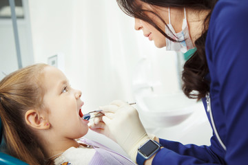 Child lies in dentist chair and goes through procedure