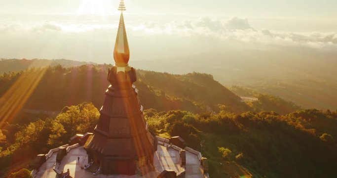 Cinematic aerial view of Buddhist temple at sunrise