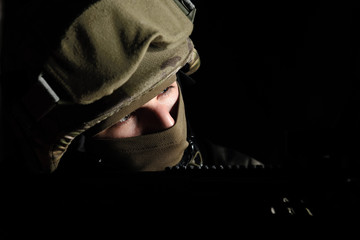 The man in the image of a member of the SWAT police with weapons