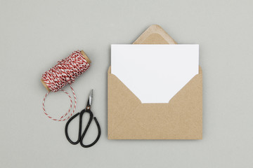Blank white card with kraft brown paper envelope template mock up