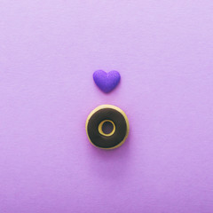 donut and heart. on a violet background. minimal. flat lay