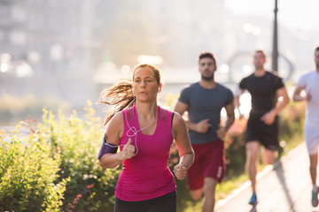 group of young people jogging in the city