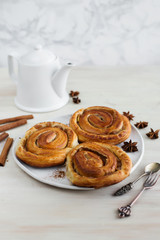 Brioche stuffed with cinnamon on a light background