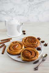 Brioche stuffed with cinnamon on a light background