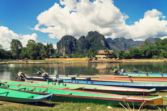 long tail boats on sunset at Song river, Vang Vieng, Laos.