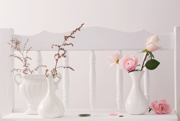 pink roses on vintage wooden white shelf