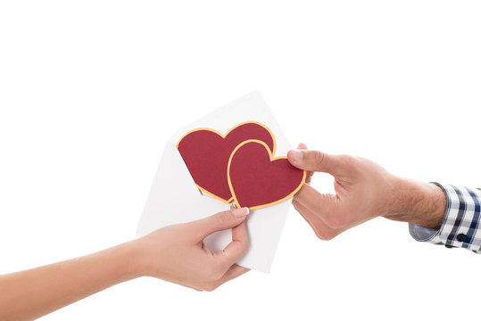 cropped image of couple holding valentines postcard isolated on white