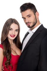 smiling attractive heterosexual couple in evening outfit isolated on white