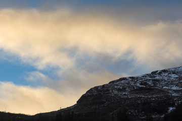 A colourful sunset over the snowcapped mountainside 