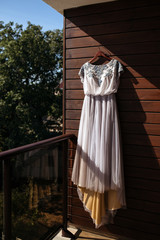 Tulle wedding dress and flower wedding decoration in boho style in the forest.