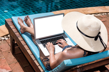 Fototapeta premium Portrait Beautiful girl Woman Using Laptop enjoying relaxing sitting deck chair near pool
