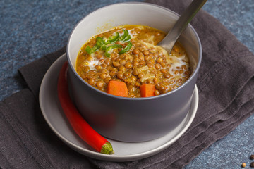Indian vegetarian lentil soup, mung dal. Indian food spice concept. Dark background, top view. Vegan Healthy Food Concept.