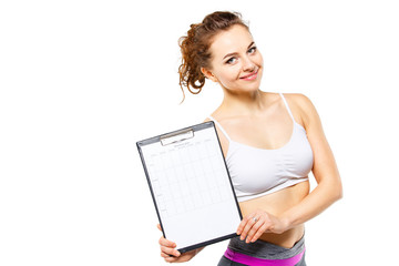 Young fitness woman holding personal workout plan isolated on white background