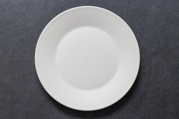 Dinner plate white table setting on dark background