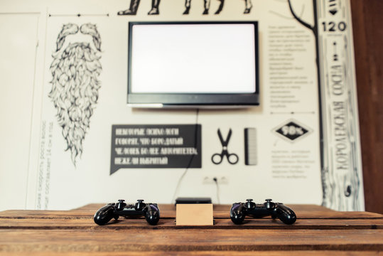 Gaming Joysticks, TV, Empty Business Card, Place For A Business Card Text On A Coffee Table