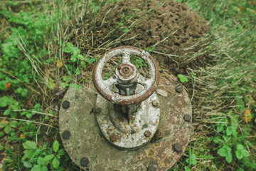 old overgrown valve on the ground