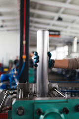 Metallurgy heavy industry. Factory for production of heavy pellet stoves and boilers. Worker hands close up. Extremely dark conditions and visible noise.